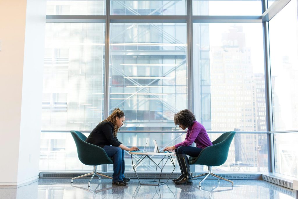 Two people sit across from each other at a small table.